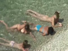 Seeing adorable MILFs taking a beach bath at the uncovered location